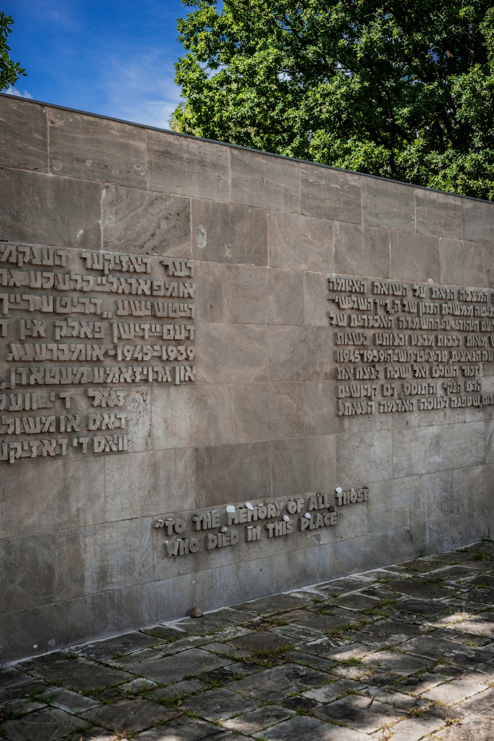 Stone memorial wall with engraved text