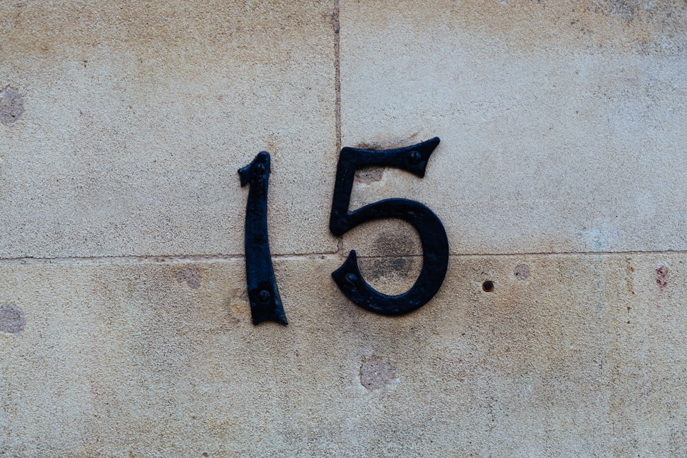 House number mounted on a stone surface